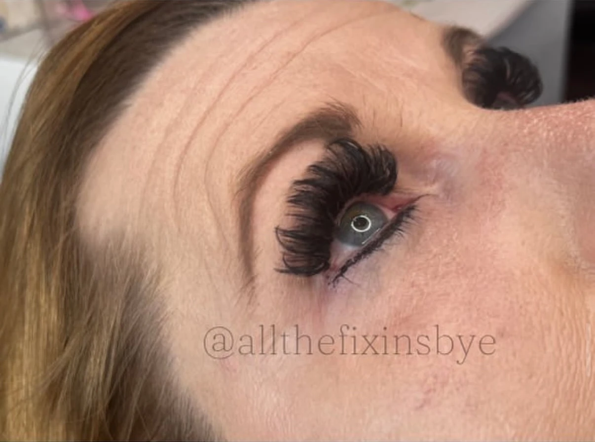 Close-up of eye with dramatic black false lashes and purple eyeshadow