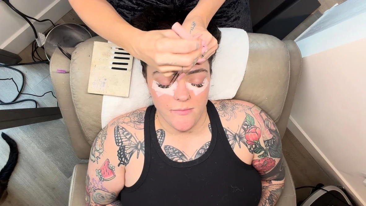Woman receiving facial treatment in medical spa chair with device on forehead